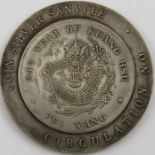 A large Chinese silver coloured Sanvple coin, year of Kuang Hsu, with dragon and characters