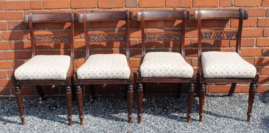 A set of four William IV simulated rosewood single dining chairs, pierced backs, on turned & fluted