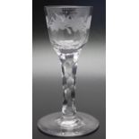 An 18th century facet stem wine glass, engraved with thistle shamrock and rose, circa 1760