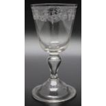 An early 18th century hollow stem wine glass, acid etched decoration circa 1750