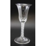 An 18th century bell bowl wine glass, with opaque spiral twist stem, on domed circular foot, with un