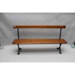 An early 20th century cast iron framed pine planked bench