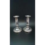 A pair of early 19th century Old Sheffield plate telescopic candlesticks, on circular bases, extende