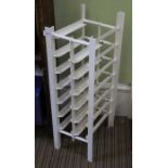 A white painted metal 12 bottle wine rack
