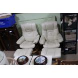 A pair of ivory reclining chairs & footstools made by Ekornes