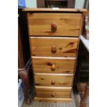 A tall narrow pine chest of five drawers