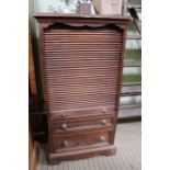 A pine tambour fronted cabinet with two further drawers