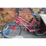 A Ladies cerise finished Raleigh off road bicycle