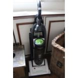 A Panasonic Eco-Max upright vacuum with attachments