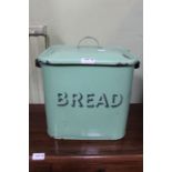 A vintage green enamelled bread crock & cover