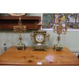 A French onyx and cast gilt metal clock garniture