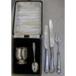 A cased hallmarked silver egg cup & spoon together with three plated serving utensils