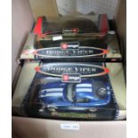 A box of Burago model cars, mostly boxed