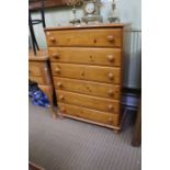 A pine chest of six full width drawers