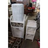 A white painted bamboo storage unit, together with a woven three tier stand and an oval lidded baske