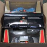 A box of Burago model cars, mostly boxed