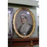 A pastel drawing of a lady in oval gilt frame