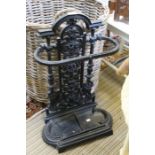 A 20th century cast metal stick stand with removable drip pan