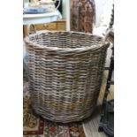 A large woven wicker log basket