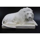 A moulded ceramic model of a recumbent lion, bears three blue factory marks to base, 9cm high