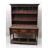 A George III oak dresser, with plate rack back,