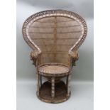 An early 1970's wicker 'Peacock' chair, with large fan back over a diablo seat natural finish with