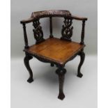 A Victorian 17th century design oak corner chair with caved horse shoe crest