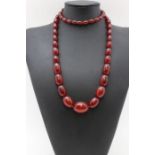 A cherry amber bakelite graduated necklace, 88cm long. weight 78g.