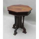 A 19th century oak lamp table of Gothic design, octagonal top, on cluster supports and four arched f