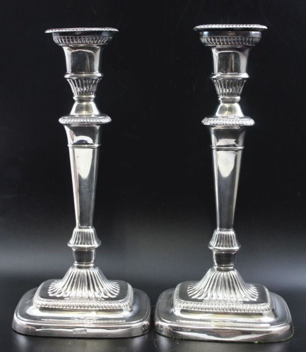 A pair of Victorian silver plated candlesticks, Adam design with gadroon borders