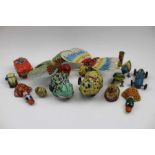 A collection of printed tin plate toys, includes; a bird, a West German made open top car, a Japanes