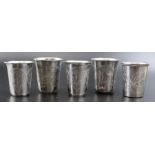 Five Russian silver vodka beakers with engraved decoration, marked 84, two dated 1870-1894