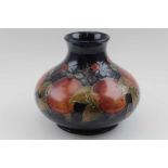 A early to mid-20th century Moorcroft pottery vase, tubed lined and painted pomegranate pattern, sig