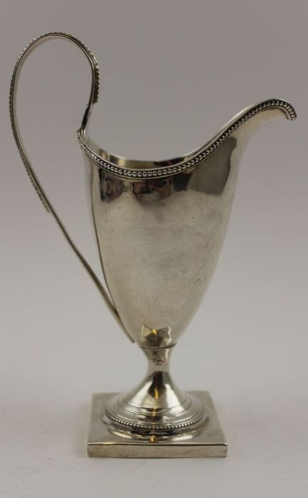 A George III silver helmet form cream jug, beaded rim and high hoop handle, on square platform base, - Image 2 of 3