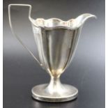 Thomas Bradbury & Sons, a late 19th century silver cream jug of tapering fluted form, weighted oval