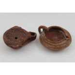 Two terracotta items of Ancient Roman form, comprising an oil lamp and a small jug