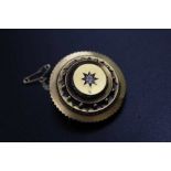 A 19th century 18ct gold brooch, circular form inset solitaire central diamond