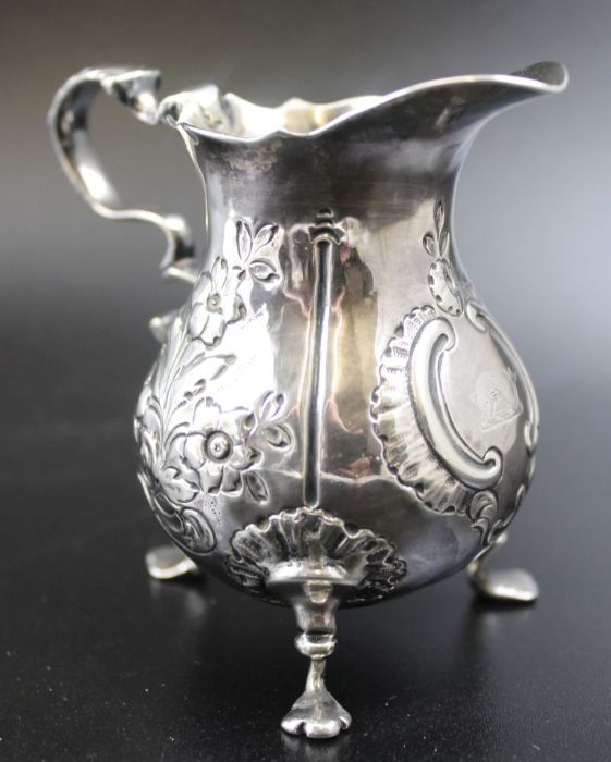 A George II silver cream jug, repousse floral decoration, scroll handle, raised on three trefoil sup - Image 5 of 6