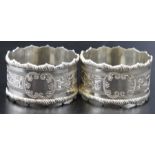 A pair of silver floral engraved napkin rings, Sheffield 1905 combined weight 55g