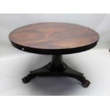 A 19th century rosewood breakfast table, plain column tri-corn plinth with three paw feet,