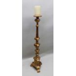 An Italian gilt wood candlestick, 129 cm tall