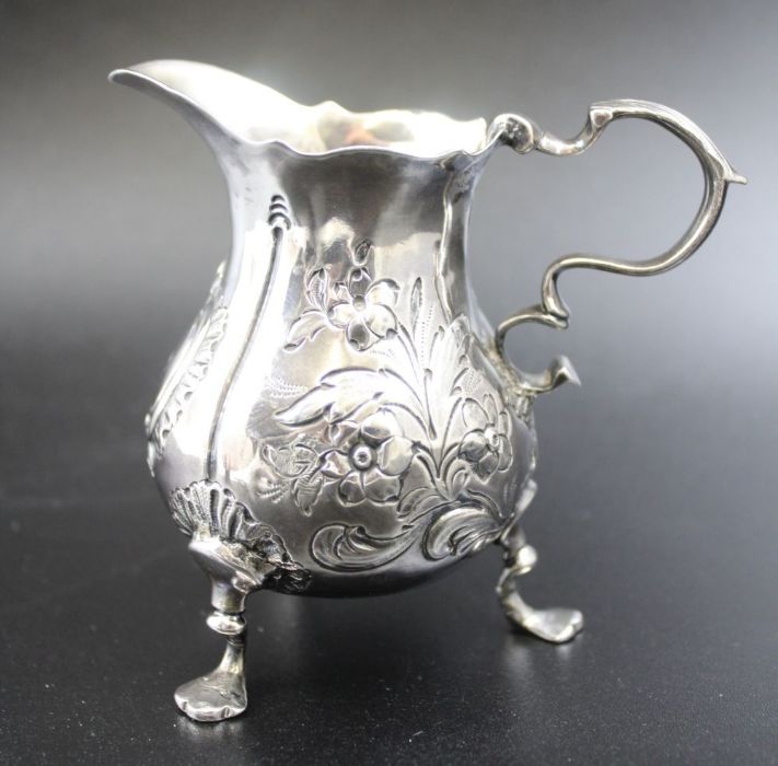 A George II silver cream jug, repousse floral decoration, scroll handle, raised on three trefoil sup - Image 4 of 6