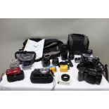 A bag of camera equipment including Pentax SF1 with a collection of lenses, A Panasonic lumix leica