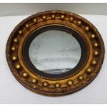 A 19th century Regency design circular gilt framed convex wall mirror, with bead set frame, overall