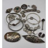 A collection of silver and white metal Art jewellery, includes; a silver boss brooch, inset malachit