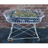 A substantial oval wire-work plant stand, 72cm x 94cm