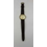 A Marvin Revue gents 9ct gold cased wristwatch, baton dial, with date aperture, and leather strap