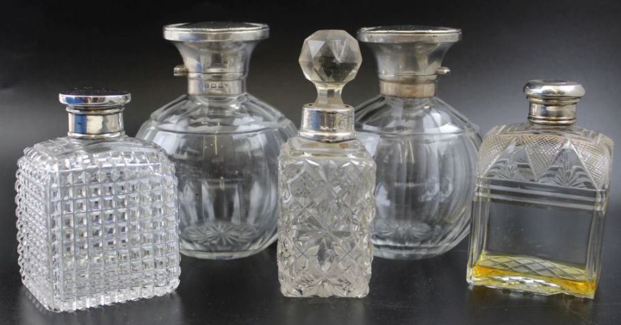 William Neale, a pair of early 20th century silver lidded facet cut globular scent bottles,