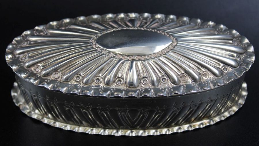 Charles Edwards, A Victorian oval embossed silver box, gilt interior, London 1888 (94g)