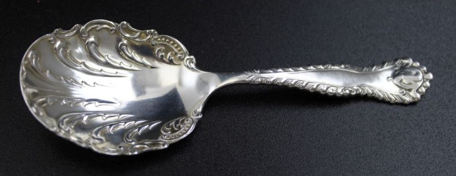 A Victorian silver tea caddy spoon, decoratively cast, scallop form bowl, Birmingham 1899, 19g